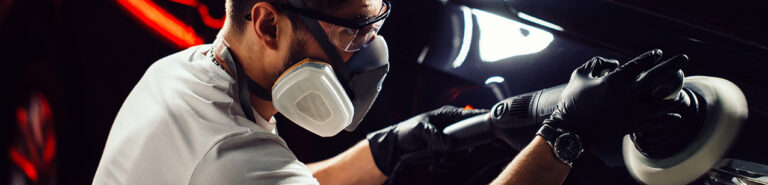 Car polish wax. worker hands holding a polisher 1 768x185